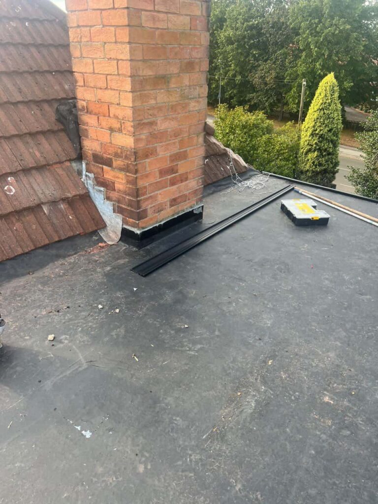 This is a photo of a flat roof which has just been repaired, there is also a chimney stack and some leadwork has also been dressed. Works carried out by LJ Roofing Abingdon
