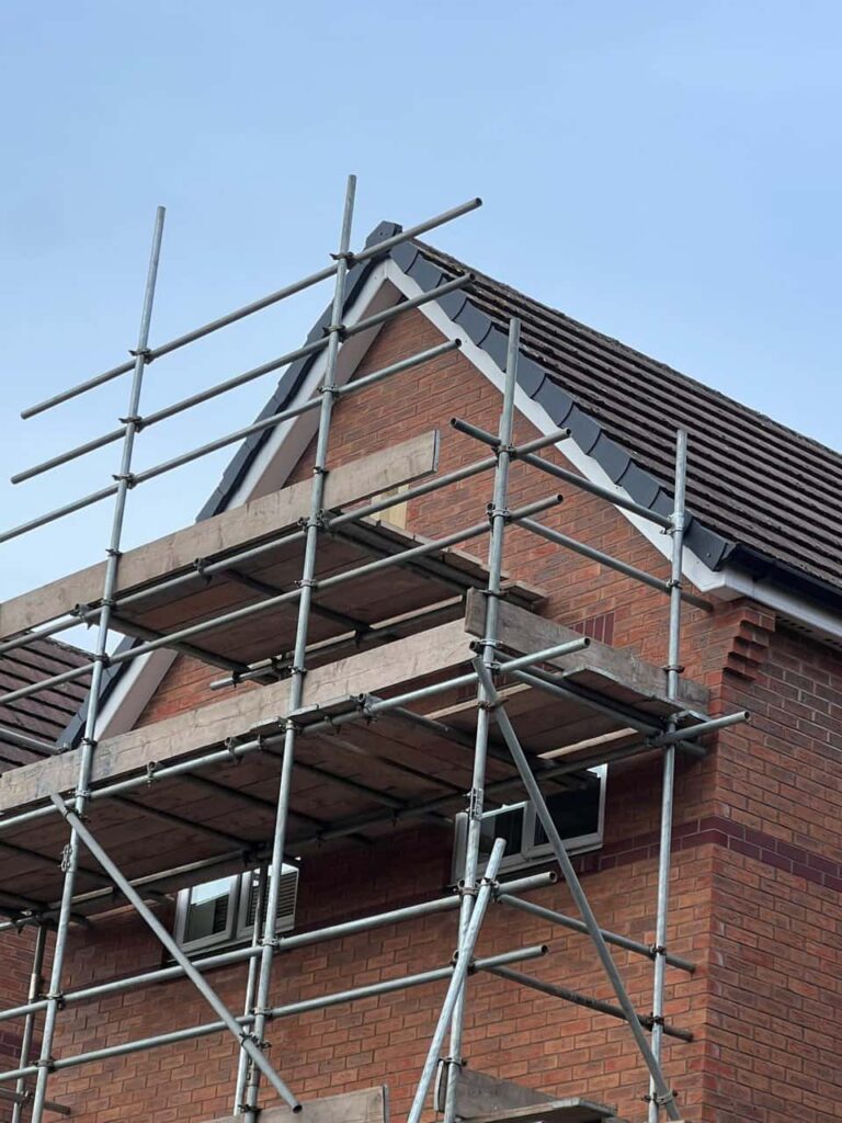 This is a photo of a roof which has just been repaired. There is a scaffold located at the gable end for access onto the roof. Works carried out by LJ Roofing Abingdon